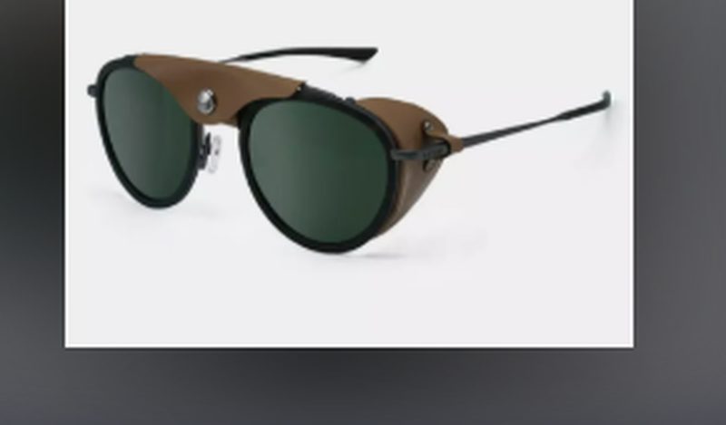 Lunettes de soleil Cébé Chill in Glacier — monture noire double étage avec œillères latérales cuir camel et verres verts.